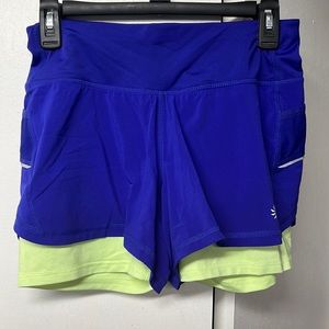 Athleta brand running shorts. Blue and lime yellow